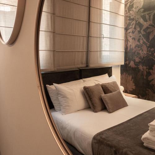 a bedroom with a bed with a mirror at Casa Abelia - Boutique Apartment in Venice