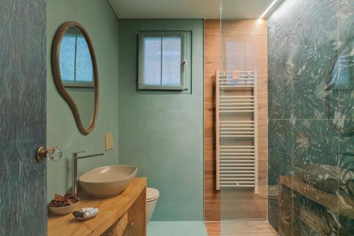 a bathroom with a sink and a toilet and a mirror at Casa Abelia - Boutique Apartment in Venice