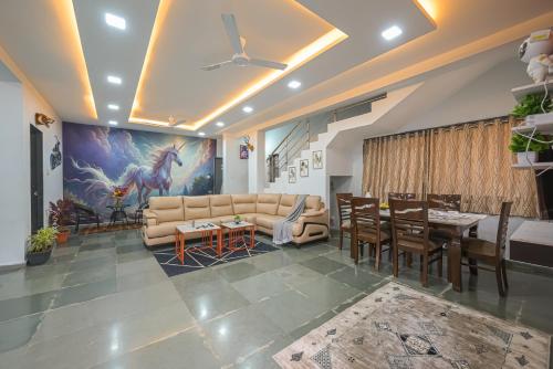 a living room with a couch and a table at ll EMPYREAN STAY ll CELESTIAL UNICORN VILLA ll 3BHK ll AC ll PVT POOL ll FREE WIFI ll in Lonavala