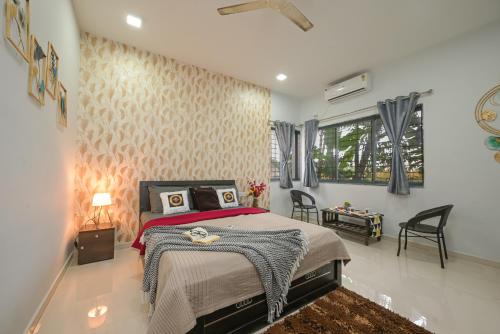 a bedroom with a bed in a room at ll EMPYREAN STAY ll CELESTIAL UNICORN VILLA ll 3BHK ll AC ll PVT POOL ll FREE WIFI ll in Lonavala