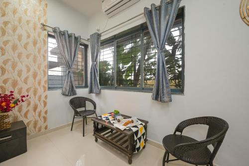a living room with two chairs and a table at ll EMPYREAN STAY ll CELESTIAL UNICORN VILLA ll 3BHK ll AC ll PVT POOL ll FREE WIFI ll in Lonavala
