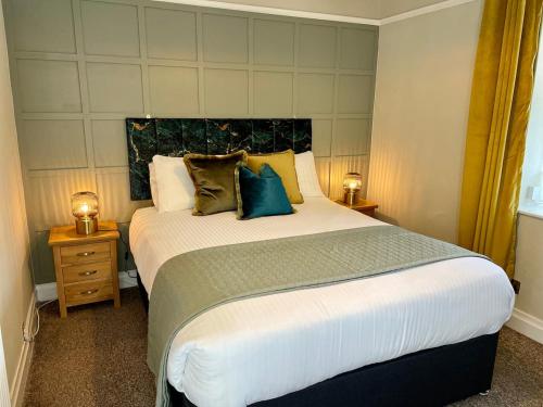 a bedroom with a large bed with pillows on it at Cosy Cottage Ambleside in Ambleside