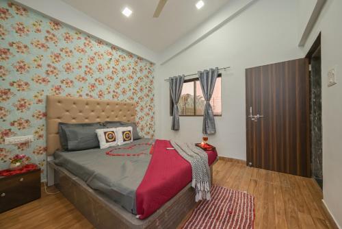 a bedroom with a large bed with a red rug at ll EMPYREAN STAY ll CELESTIAL UNICORN VILLA ll 3BHK ll AC ll PVT POOL ll FREE WIFI ll in Lonavala