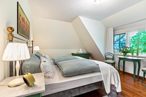 a bedroom with a bed and a table with a lamp at Das Deichhaus in Norddeich