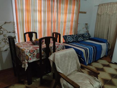a small bedroom with a bed and a chair at Miraflores 2- Calor de Hogar in Asuncion