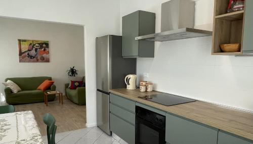 eine Küche mit einer Theke und einer Couch in einem Zimmer in der Unterkunft Casa Rio Maggiore in Levico Terme