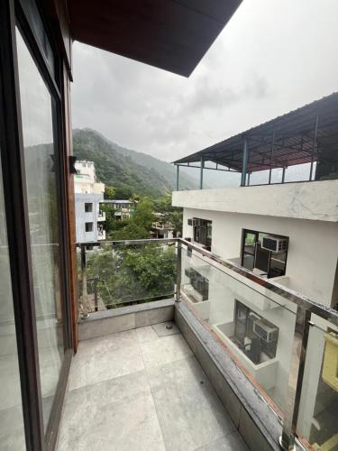 a balcony with a view of a building at Hotel Krishna in Rishīkesh