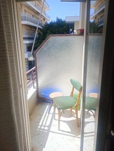 a balcony with two chairs and a table at The cabin in Loutraki