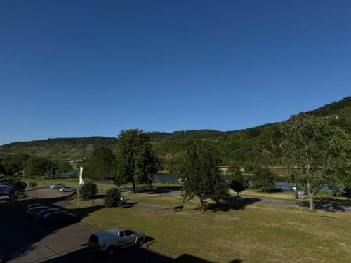 a car parked in a parking lot with mountains in the background at Casa del Mondo in Sankt Aldegund