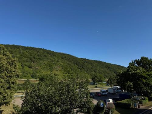 a mountain with cars parked in a parking lot at Casa del Mondo in Sankt Aldegund
