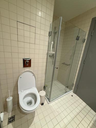 a bathroom with a toilet and a glass shower at Private Studio 4 pax in Euphoria Club in Borovets