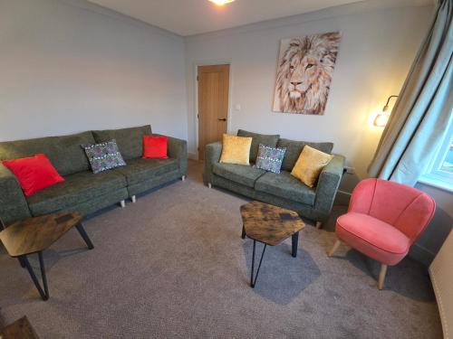 a living room with a couch and two chairs at Kinsale House by Cliftonvalley Apartments in Brislington
