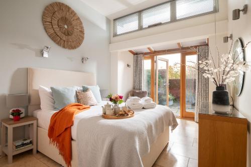 a bedroom with a bed with towels on it at The Garden House in Waterden