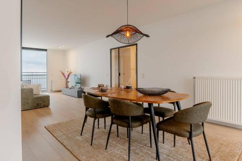 a dining room with a wooden table and chairs at Hello Zeeland - Appartment Port Scaldis 07-031 in Breskens