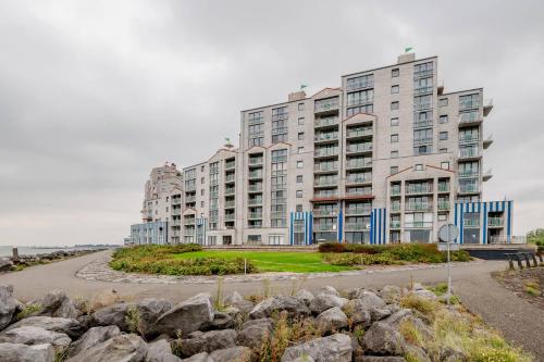 a large apartment building on a road next to rocks at Hello Zeeland - Appartment Port Scaldis 07-031 in Breskens