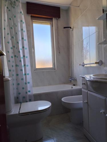a bathroom with a tub and a toilet and a sink at El Solano-La Gallega in La Gallega