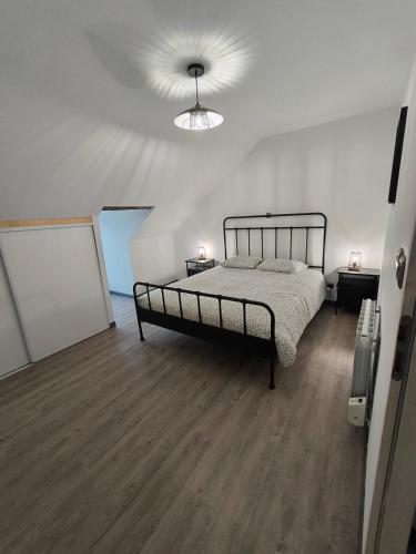 a bedroom with a bed and a ceiling at L'étoile de rocroy in Rocroi