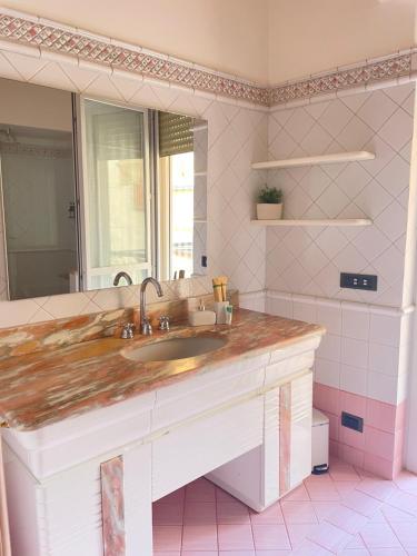 a bathroom with a sink and a mirror at La casa di Erika in Almè