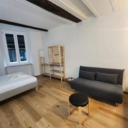 a living room with a bed and a couch at Torta Zena Poldo in Genova