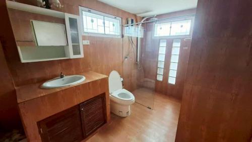 une salle de bain avec toilettes, lavabo et miroir dans l'établissement Araya's House, à Hua Hin