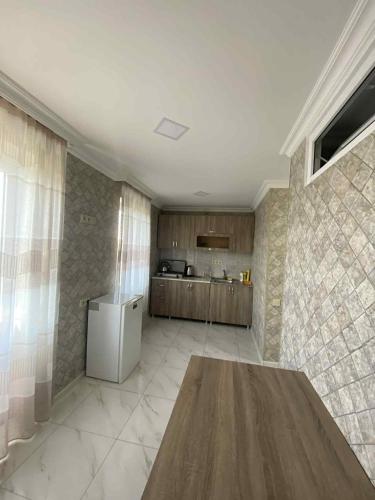 a kitchen with a table and a refrigerator at Ruslan Hootel 3 in Poti