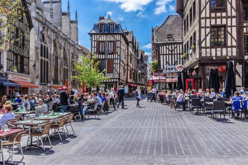 a crowd of people sitting at tables in a city street at Le Troyes Coeur in Troyes
