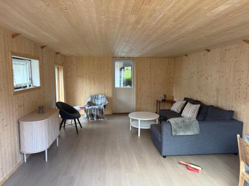 a living room with a couch and a table at Fantastic house with seafront property in Gryllefjord in Gryllefjord