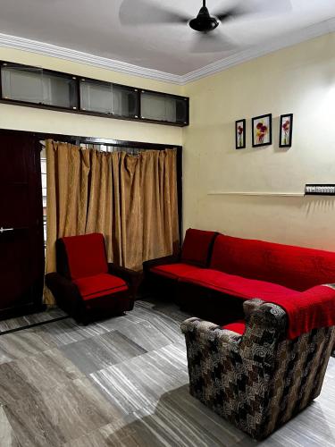 a living room with a couch and a chair at The Padmavathi Homestay in Visakhapatnam