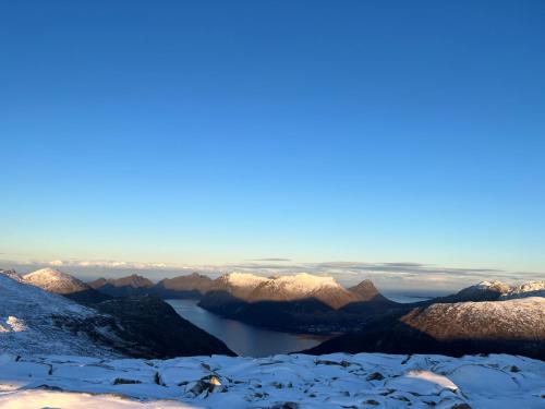 a view from the summit of snow covered mountains at Fantastic house with seafront property in Gryllefjord in Gryllefjord