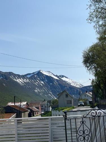a view of snow covered mountains from a town at Fantastic house with seafront property in Gryllefjord in Gryllefjord