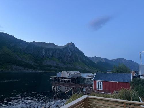 a house on a dock next to a body of water at Fantastic house with seafront property in Gryllefjord in Gryllefjord