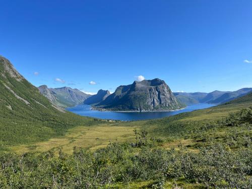 a view of a mountain and a lake at Fantastic house with seafront property in Gryllefjord in Gryllefjord
