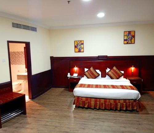 a hotel room with a large bed and a television at Ramee California Hotel in Manama