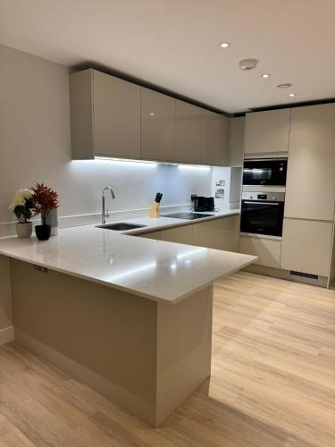 a kitchen with a white counter top and a sink at Apartment with Terrace in Uxbridge in Uxbridge