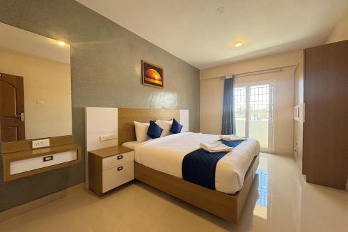 a bedroom with a large bed and a window at The Pearl Residency 2BHK 3BHK Apartments in Ooty