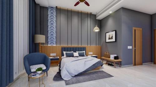 a bedroom with a bed and a blue chair at Parin Azure Hotels & Resorts in Amritsar