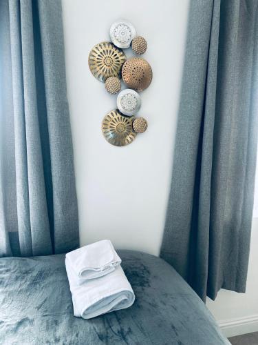 a bedroom with a bed with blue drapes and plates at Burton Urban Apartment in Burton upon Trent