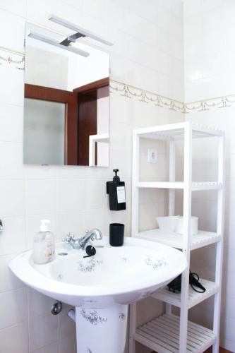 a bathroom with a sink and a mirror at BayHouse in Porto Martins