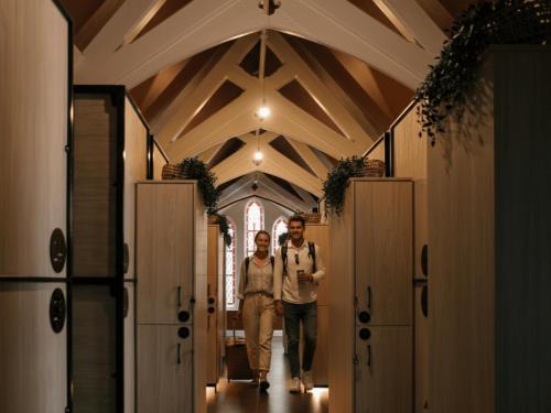 a man and a woman walking down a hallway at Gardiner House Hostel in Dublin