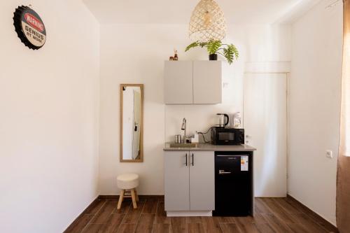 a kitchen with a black and white cabinet and a mirror at Rena's House - Beach Edition in Tel Aviv