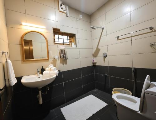 a bathroom with a sink and a toilet at Anand homestay in Kattappana