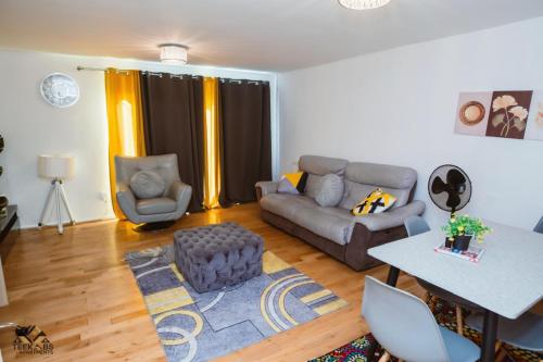 a living room with a couch and a table at Modern 2 bedroom Terrace in Woolwich