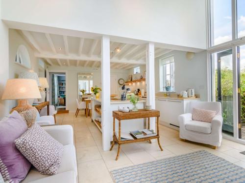 a living room with white furniture and a kitchen at 2 Bed in Goudhurst 51229 in Goudhurst