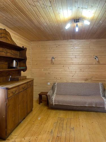 a bedroom with a bed in a wooden room at Під каштаном in Vorokhta
