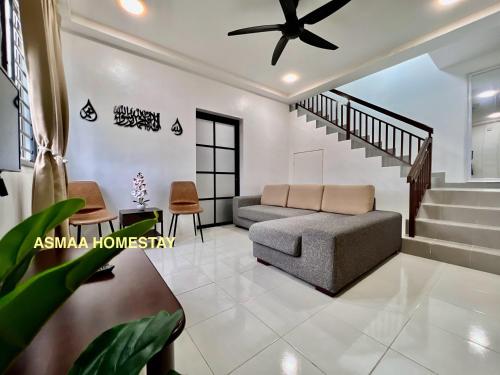 a living room with a couch and stairs at Asmaa Homestay Kota Masai Pasir Gudang in Pasir Gudang