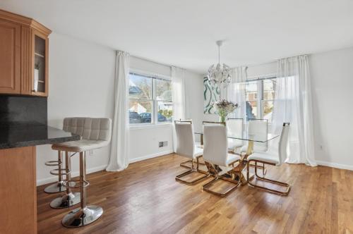 a kitchen and dining room with a glass table and chairs at Luxury NY Home with Game Room and Free Parking in White Plains