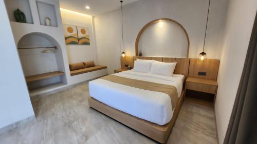 a bedroom with a large white bed in a room at JBS Villa in Yogyakarta