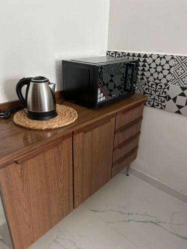 a microwave sitting on top of a wooden cabinet at Casa di Paolo in Castrocaro Terme