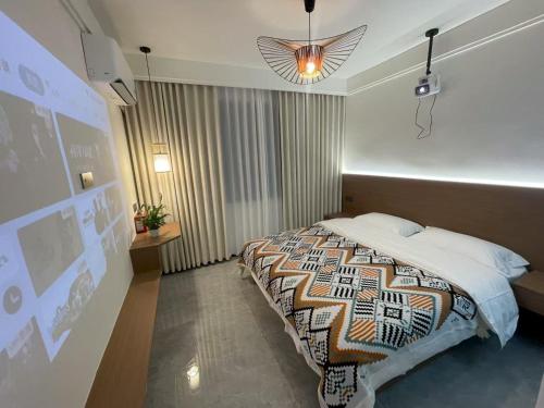 a bedroom with a bed in a room with a wall at Qingwu Lane in Luoyang
