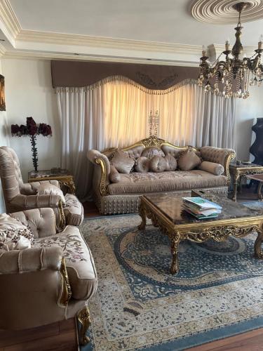 a living room with a couch and a coffee table at Atlantis Palace Pyramids View in ‘Ezbet `Abd el-Ḥamîd